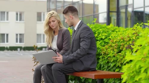 Business Colleagues Using Laptop and Talking