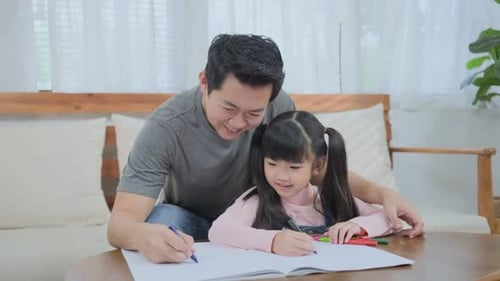 Loving Father and Daughter Drawing Together at Home