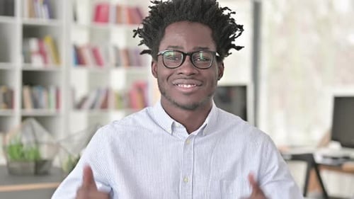 Smiling Young Adult Gives Two Thumbs Up