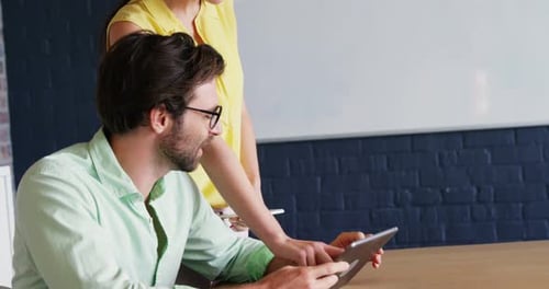 Business Colleagues Work Together Using a Tablet