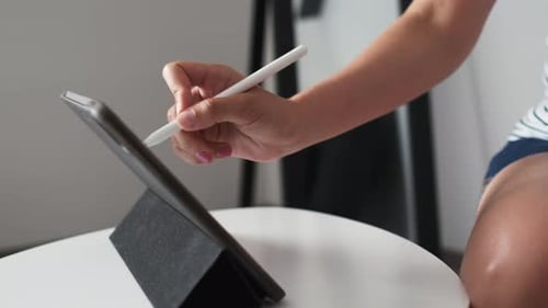 Hand Using Stylus on Tablet Device