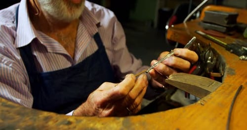 Goldsmith manufacturing jewellery in workshop 4k