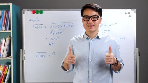 Man Smiling and Giving Thumbs Up By Whiteboard