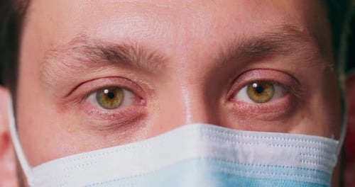 Close Up of Man Wearing Surgical Mask