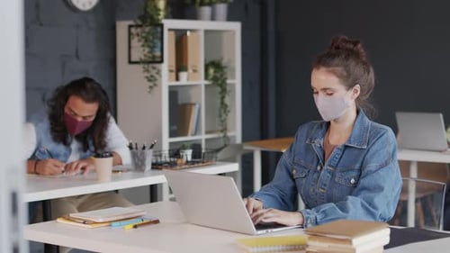 Young Businesspeople in Face Masks Working in Office