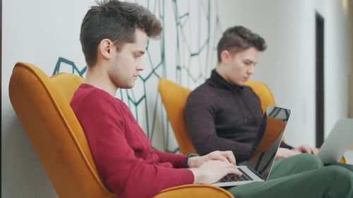Colleagues Programmers Are Looking on Monitor and Typing on Keyboard in office.Casual Businessmen