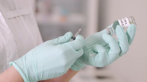 Drawing COVID Vaccine into Syringe in Hospital