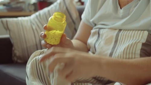 Man Taking Handful of Pills