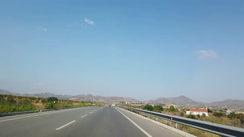 The View From the Window of a Car That Rides on a Beautiful Road