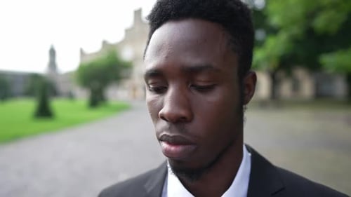 Well-Dressed Man Tips Hat in City
