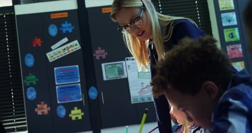 Teacher Helps Students with Class Work