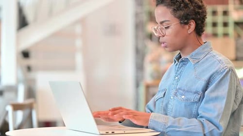 African Woman with Laptop Standing Up and Going Away