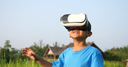 Boy Using Virtual Reality Headset in Rural Setting