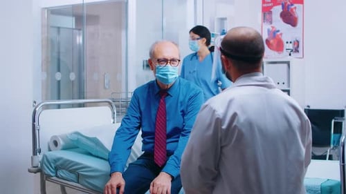 Doctor Speaking With Patient in Hospital Room
