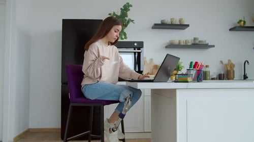 Woman with Prosthetic Leg Working at Kitchen Counter