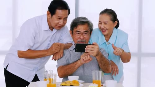 Cheerful Senior Friends Taking Picture Together on Cell Phone