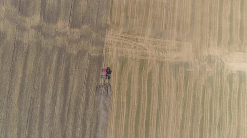 Aerial view of a tractor plowing on the fields