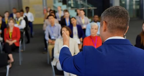 Man Presents To Audience At A Conference