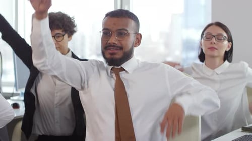 Diverse Businesspeople Doing Exercises in Office
