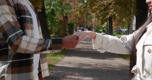 Romantic Couple Holding Hands in an Urban Park