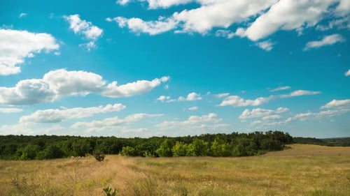 Bewegte Wolken im blauen Himmel über Landschaftsfeldern. Zeitraffer. Wunderbares ländliches Tal.
Ukraine