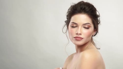 Beautiful Woman Posing in Studio with Glamorous Makeup