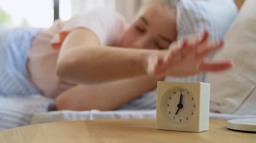 Woman Wakes Up in Bed to Alarm Clock