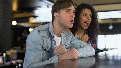 Couple Cheering and Celebrating at Bar Together