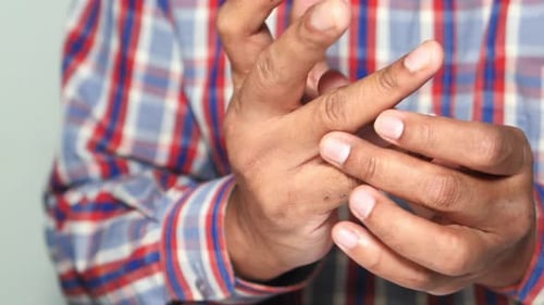 Man Suffering Pain in Finger Close Up