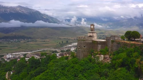 Gjirokaster castle tower clock overlooking the river valley, Albania. Aerial wide view