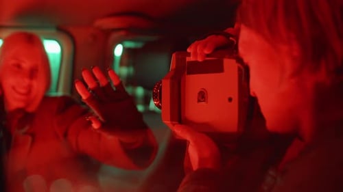 Woman Posing in Back of a Van at Night