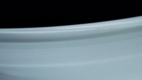 Undulating Flowing Material on Black Background