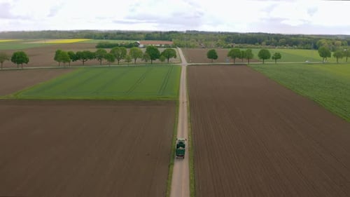 Scenic Aerial View of Farm Fields and Tractor