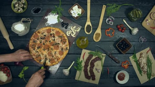 Overhead View of Pizza Preparation and Cutting