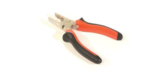 Pair of metal pliers rotating on white background