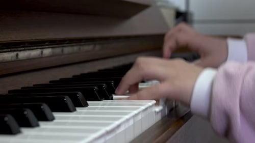 Child playing piano. Close up