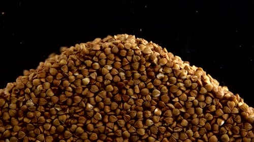 Buckwheat Seeds Pouring onto Pile Close Up
