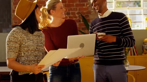 Team Laughing and Working Together in Office