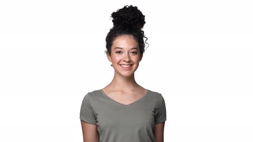 Portrait of Joyful Pretty Woman 20s with Dark Curly Hair Looking at Camera with Happy Smile Isolated