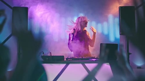 Blonde Singer Performing as DJ in Nightclub