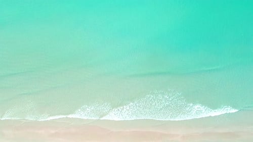 4K Aerial view top view of drone, sea waves and beautiful sand beach.