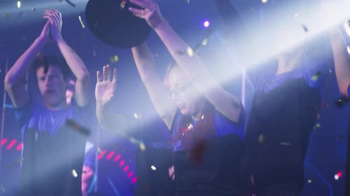 Female Gamer Raising Trophy Near Teammates