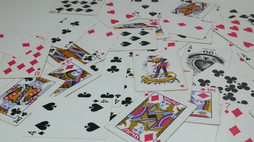 Scattered Playing Cards on a White Surface