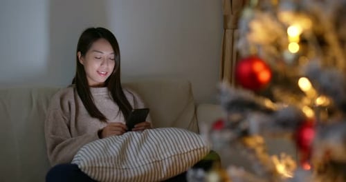Woman Using Smartphone at Christmas Time
