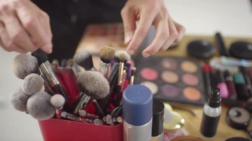 Hands of Make-Up Artist Choosing Brush