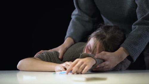 Distraught Young Adult with Syringe Gets Support