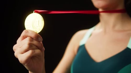 Young Woman Holding a Gold Winning Medal