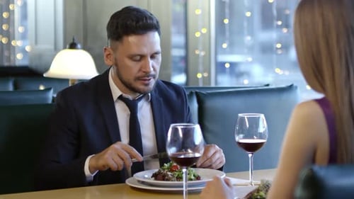 Man Chatting with Girlfriend on Date in Restaurant