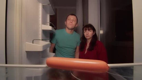 Couple Checks Nearly Empty Fridge at Night