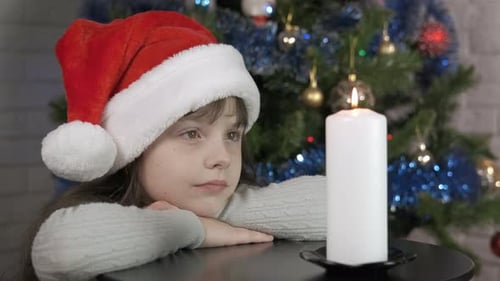 Child Relaxing Christmas Night with a Candle